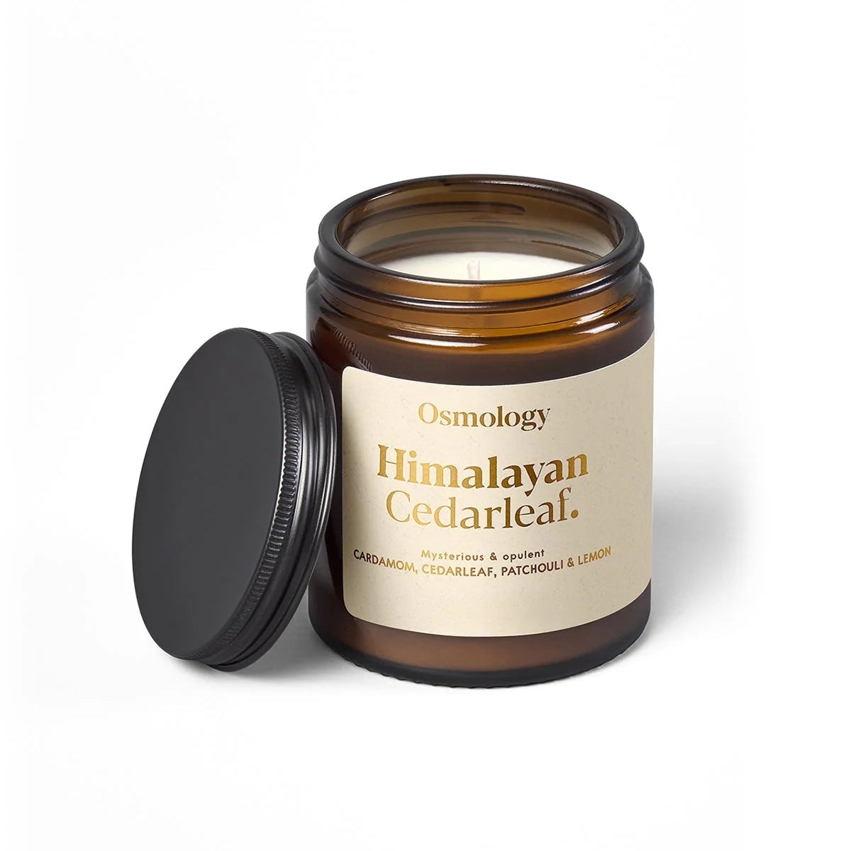 Osmology Himalayan Cedarleaf candle with a black lid on a white background