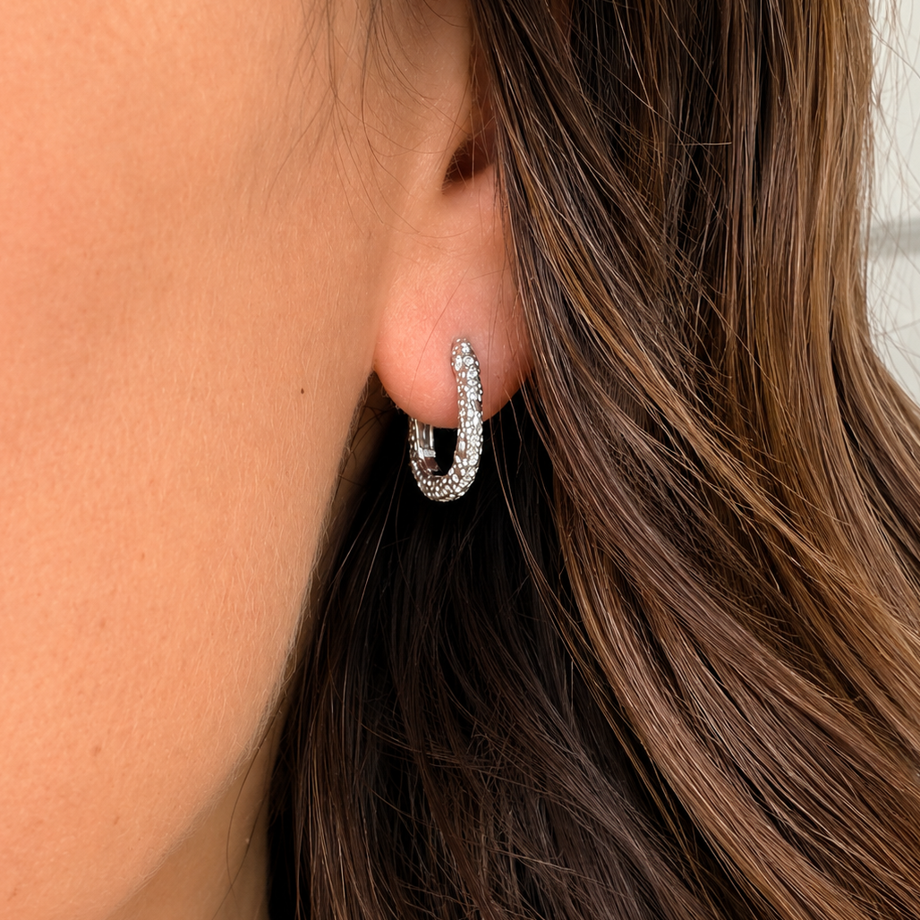 silver hoop on an ear