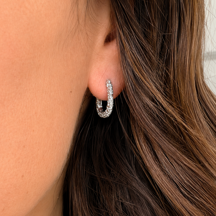 silver hoop on an ear